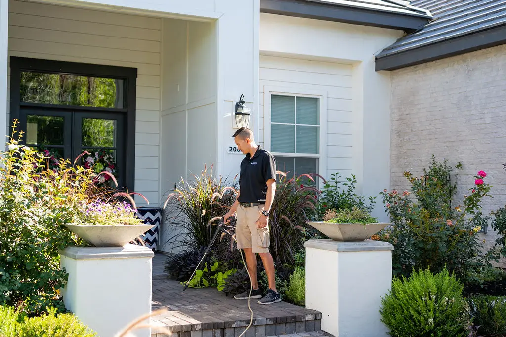 Map of Arizona Technician cleaning tile and grout during a home service.